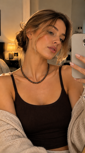 Bronze serpent necklace displayed on silk fabric