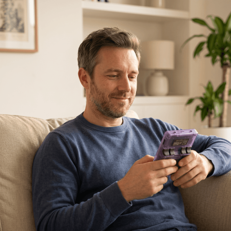 Person playing the Marssirace Pro 2.0 R36S retro gaming console at home